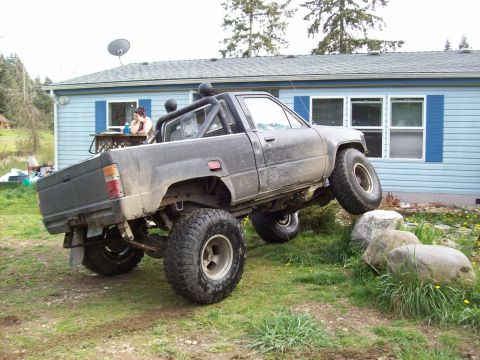 1985 Toyota Pickup/SR5 - Modified 1985 Toyota Pickup/SR5 with lifted suspension and large tires is shown off-road.