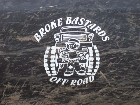 1985 Toyota Pickup/SR5 - Sticker graphic shows a cartoon character and a monster truck with text 'BROKE BASTARDS OFF ROAD'.