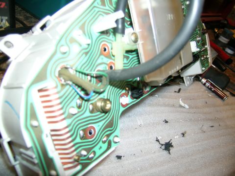 1995 Ford Probe - Close-up view of a car's dashboard circuit board, showing intricate wiring and electronic components.