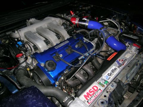 1995 Ford Probe - Close-up of a modified engine bay, likely a turbo build, showing custom piping and components.