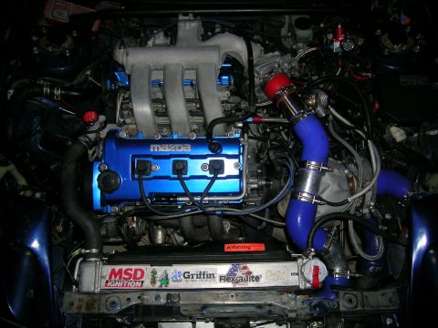 1995 Ford Probe - Modified Mazda engine bay custom turbo piping and blue accents.