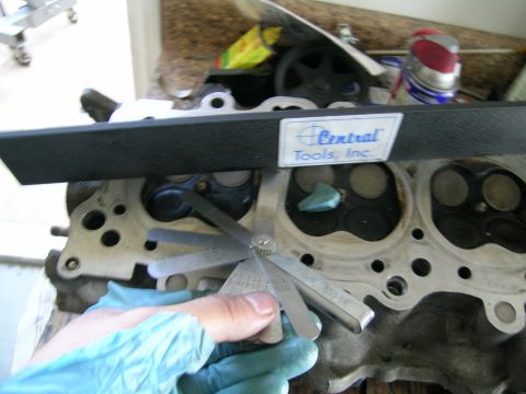 1995 Ford Probe - Checking valve clearances on an engine cylinder head with a set of feeler gauges.