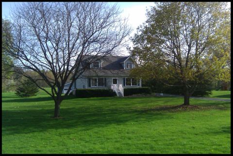 1966 Ford Five Hundred - A suburban house sits on a well-kept lawn, framed by trees. The SUPERMOTORS.NET logo is visible in the lower right corner.