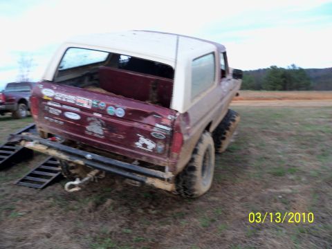 1978 Ford Bronco - This 1978 Ford Bronco is shown from the rear, equipped with mud tires and numerous stickers on its tailgate.