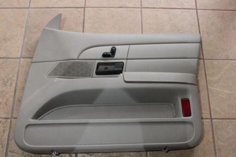 2007 Ford Crown Victoria - Gray interior door panel with controls and speaker grille, likely for a sedan.