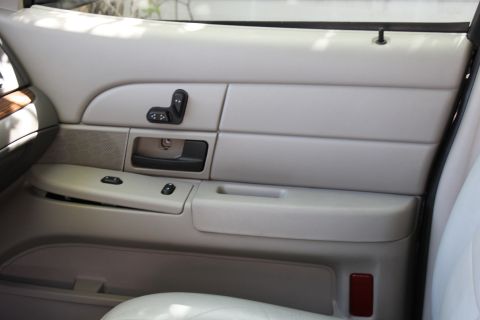2007 Ford Crown Victoria - Interior view of a 2007 Ford Crown Victoria passenger side door panel, showing seat and window controls.