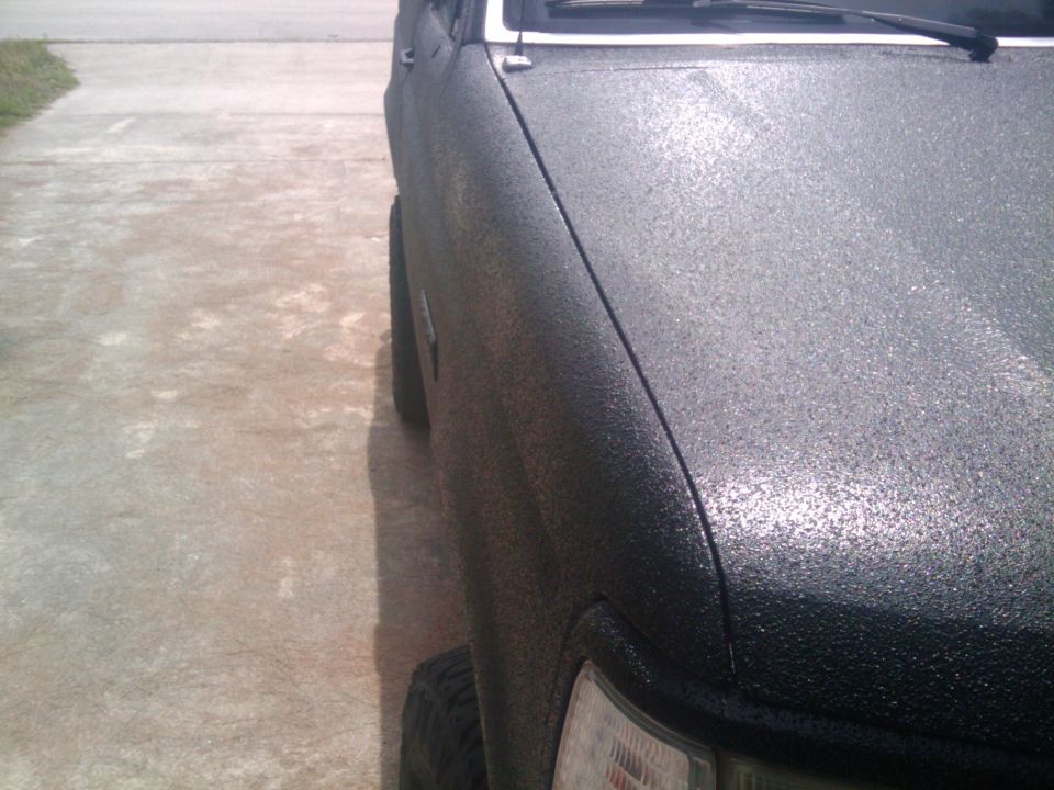 1993 Ford Bronco side view showing textured black paint on fender and tire