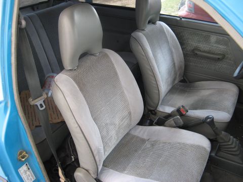 1991 Ford Festiva - Interior view of a 1991 Ford Festiva, showing the front seats and dashboard details.