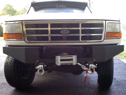1996 Ford Bronco - This Ford truck features a chrome grille and an aftermarket bumper with a winch installed.