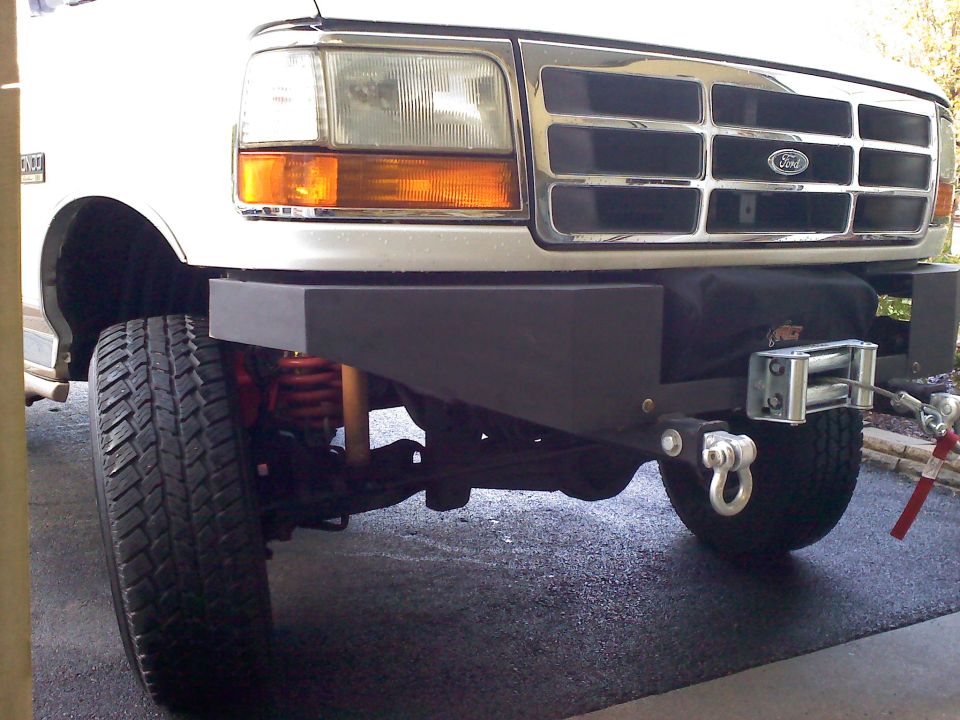 White Ford Bronco front end with chrome grille and aftermarket bumper with winch