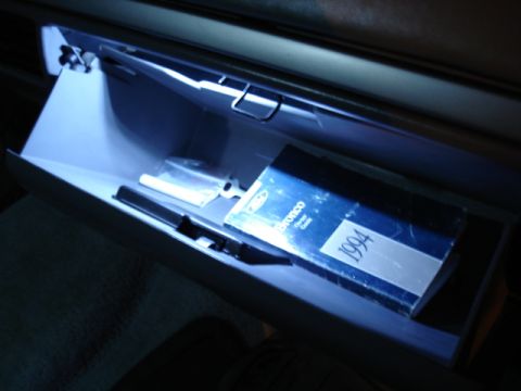 1996 Ford Bronco - The glove compartment is illuminated, revealing a 1994 Ford Bronco owner's manual inside.