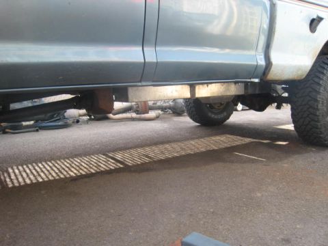 1976 Ford F-250 - Side view of a 1976 Ford F-250's undercarriage, showing the frame, exhaust, and suspension.
