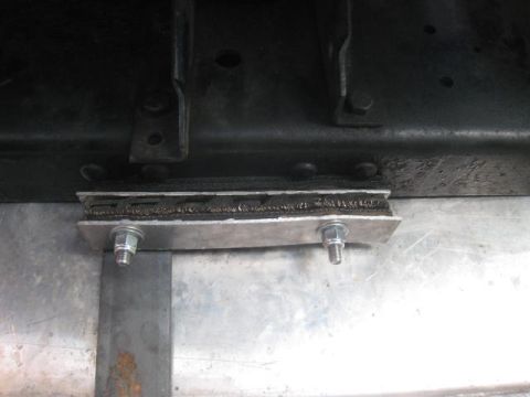 1976 Ford F-250 - Close-up of a custom body mount a rubber isolator and two bolts, likely part of a vehicle modification.