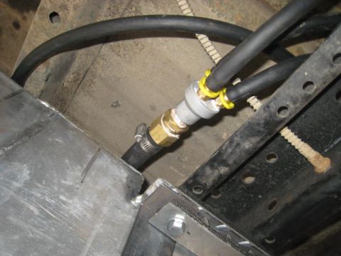1976 Ford F-250 - Close-up of fuel line fittings and hoses, likely part of a custom fuel system installation.