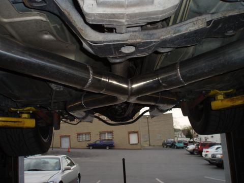 2002 Chevrolet Camaro - Custom dual exhaust system with an X-pipe crossover is visible on the undercarriage of a vehicle.