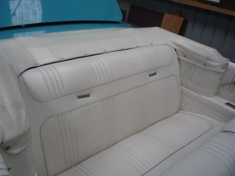 1964 Mercury Monterey - The white vinyl interior of a 1964 Mercury Monterey convertible shows off its distinctive seat stitching and door panel details.