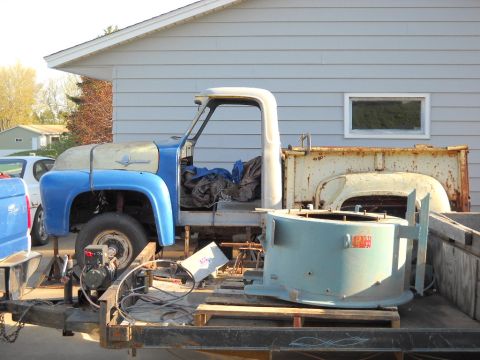 1954 Ford F-100 - This 1954 Ford F-100 truck is seen on a trailer, appearing to be a "mock up" project with some parts removed.