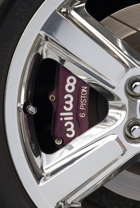 2003 Mercury Marauder - Close-up of a purple Wilwood 6 Piston brake caliper behind a chrome wheel.