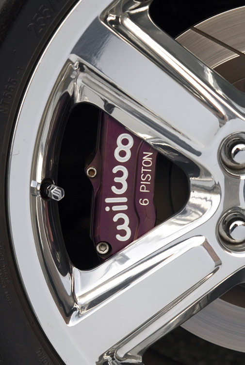 Purple Wilwood 6-piston brake caliper behind a polished multi-spoke wheel
