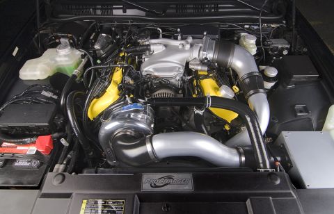 2003 Mercury Marauder - The engine bay features a ProCharger supercharger and custom yellow valve covers.