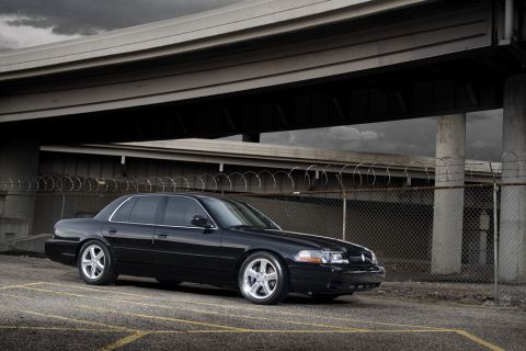 2003 Mercury Marauder - A black 2003 Mercury Marauder is captured from a 3/4 front angle under a concrete overpass.