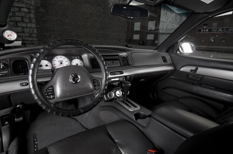 2003 Mercury Marauder - The interior of a 2003 Mercury Marauder features white-faced gauges and a tachometer mounted on the dash.
