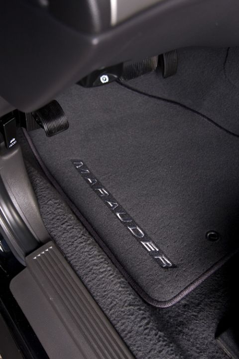 2003 Mercury Marauder - Close-up of embroidered 'Marauder' floor mats inside a vehicle.