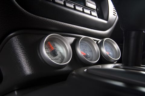 2003 Mercury Marauder - Close-up of a car's interior dashboard showing multiple gauges and the gear shifter.