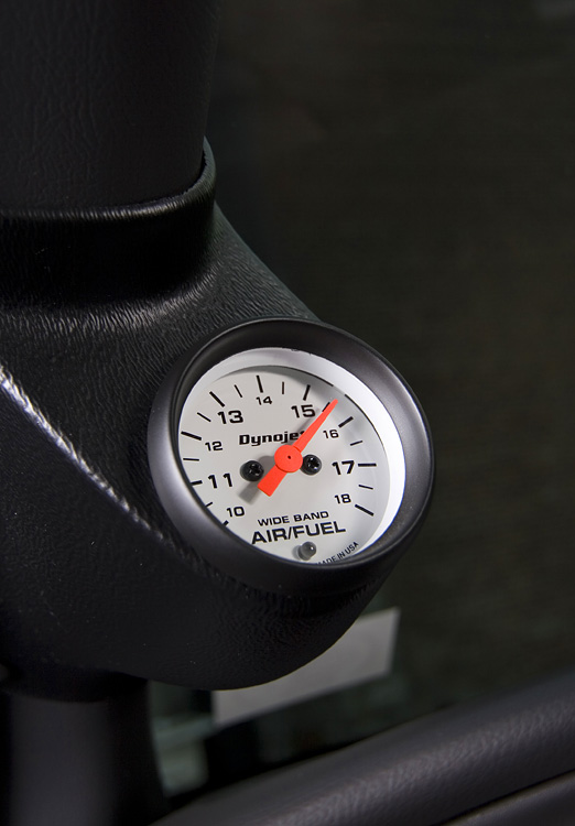 Dynojet wideband air/fuel gauge in a black A-pillar pod, needle near 15