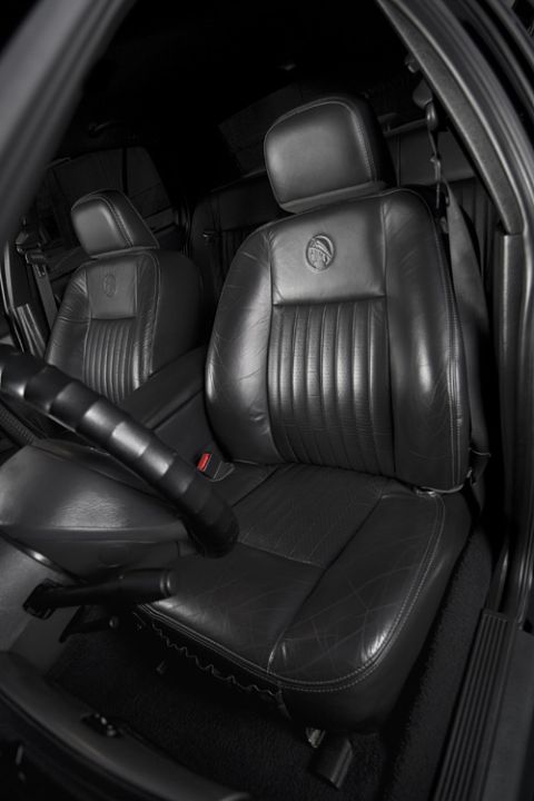 2003 Mercury Marauder - Interior view of a 2003 Mercury Marauder, highlighting the black leather seats with the distinctive Mercury emblem on the headrests.