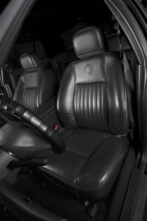 Black leather Mercury Marauder front bucket seats with embroidered emblem on the seatbacks