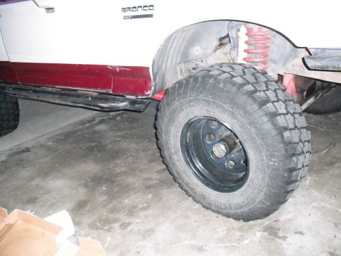 1991 Ford Bronco - Close-up of the side panel and wheel well of a 1991 Ford Bronco.