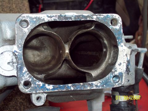 1995 Ford Probe - Intake manifold ports show wear and chipping paint around the mounting flange.