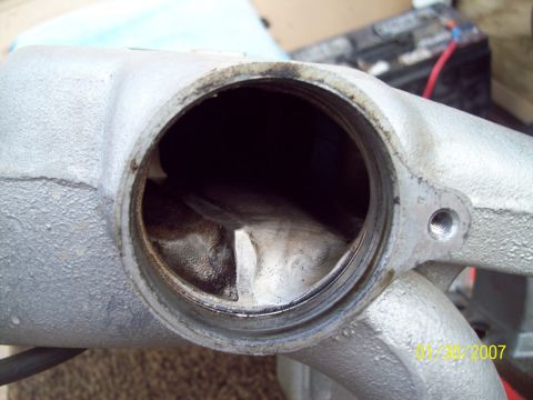 1995 Ford Probe - Close-up of an intake manifold part, showing internal wear and a date stamp from 2007.