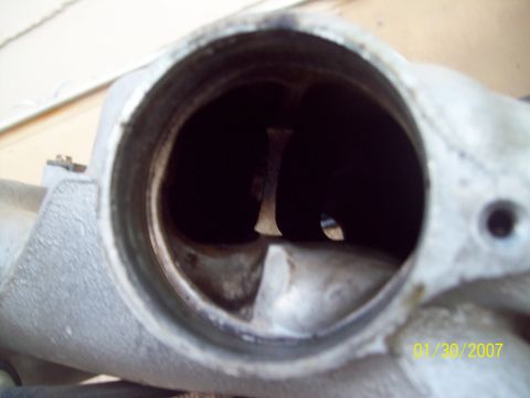 1995 Ford Probe - This is a close-up view of the inside of an engine's intake manifold, showing the openings for air or fuel to pass through.