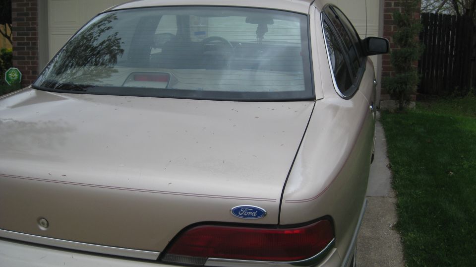 Tan 1992 Ford Crown Victoria rear view, showing taillight and Ford emblem