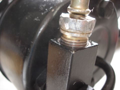 1992 Ford Bronco - Close-up of a threaded high-pressure hose fitting with a hex nut screwing into a black cast metal component, likely a power steering pump.…