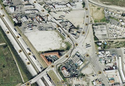 1968 Ford Mustang - Aerial view shows a highway interchange with numerous vehicles and commercial buildings.
