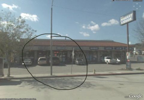 1968 Ford Mustang - A row of storefronts, including a market and liquor store, are visible under a tiled roof with cars parked in front.