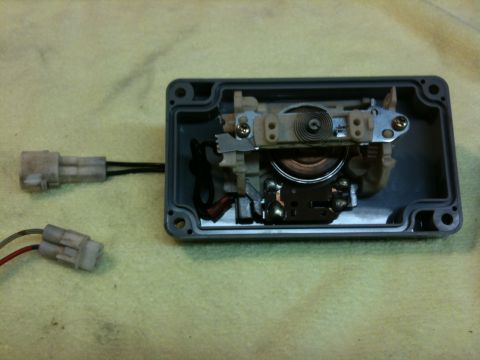 Suzuki Samurai - A throttle position sensor with its internal components and two electrical connectors is shown.