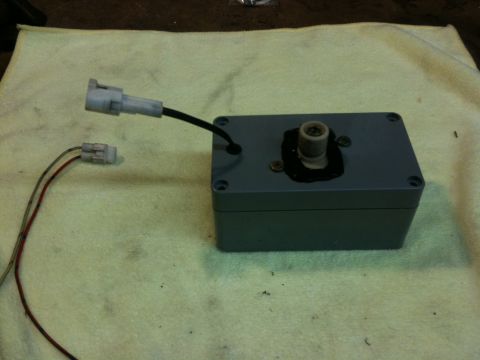 Suzuki Samurai - Automotive electrical component with two wire harnesses attached, resting on a cloth.