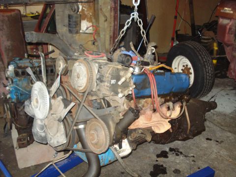 1979 Ford Bronco - An engine assembly, likely removed from a vehicle, is shown with various components attached.