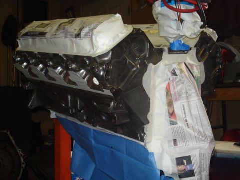 1979 Ford Bronco - Engine block masked off and prepared for a paint job in a workshop setting.