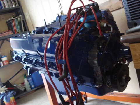 1979 Ford Bronco - A blue V8 engine is mounted on an engine stand, ready for installation or work.