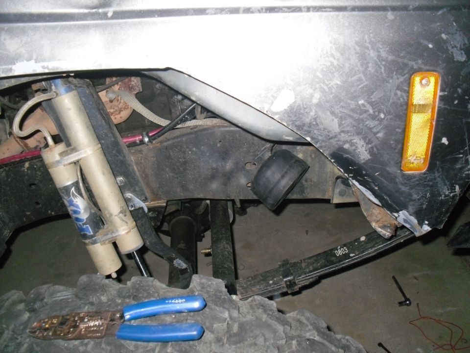 1984 Ford Bronco II rear suspension with Fox shocks and leaf springs, tire and tools visible
