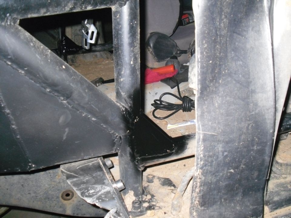 interior view of a roll cage with a coiled cable and a red cloth on the floor