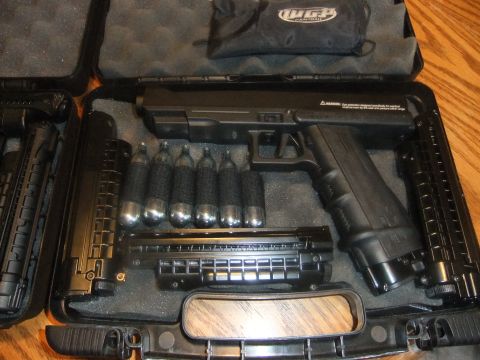 1978 Chevrolet C/K Pickup - A black paintball gun, CO2 cartridges, and magazines are neatly arranged in a protective case.