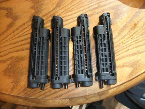 1978 Chevrolet C/K Pickup - Four black gun magazines are displayed on a wooden surface, likely for sale or inventory.