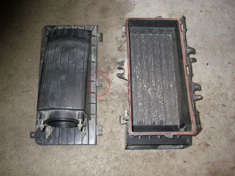 1990 Ford Bronco - Separated Ford Bronco air cleaner housing shows the Ford logo on the top section.