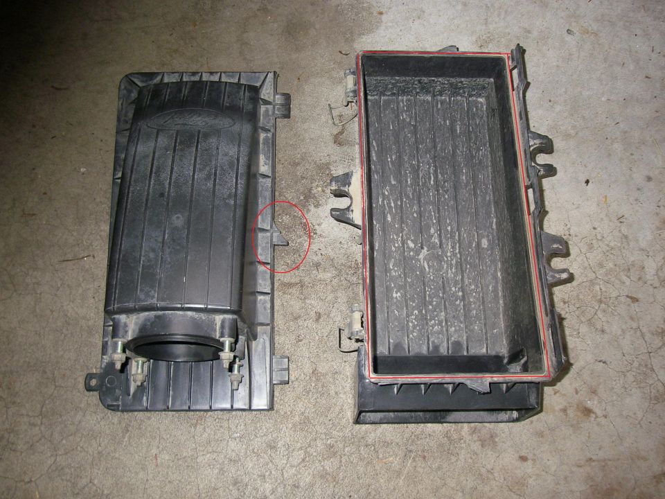 Ford Bronco air cleaner housing, top and bottom halves separated. Ford logo visible on top